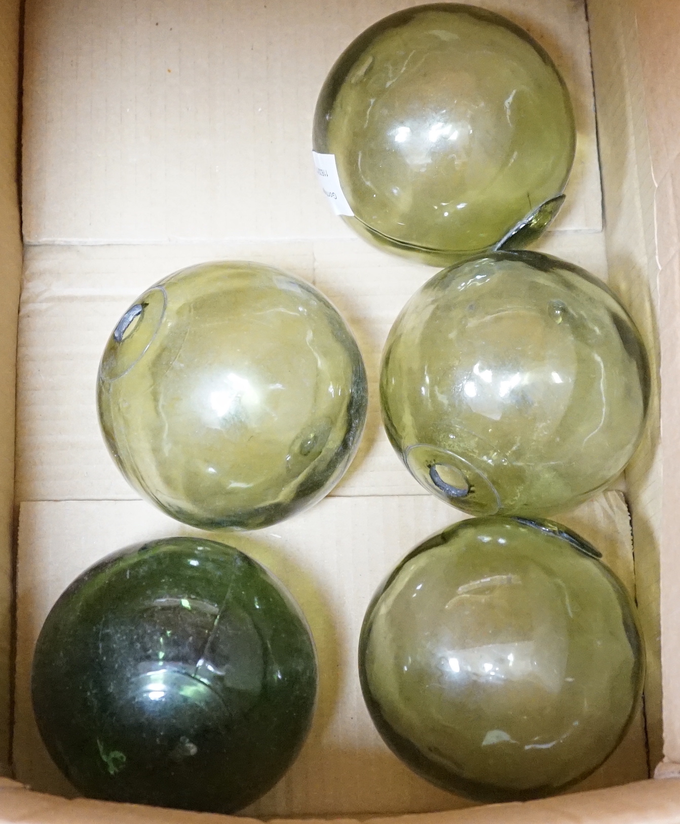 A group of green glass fishermen’s balls